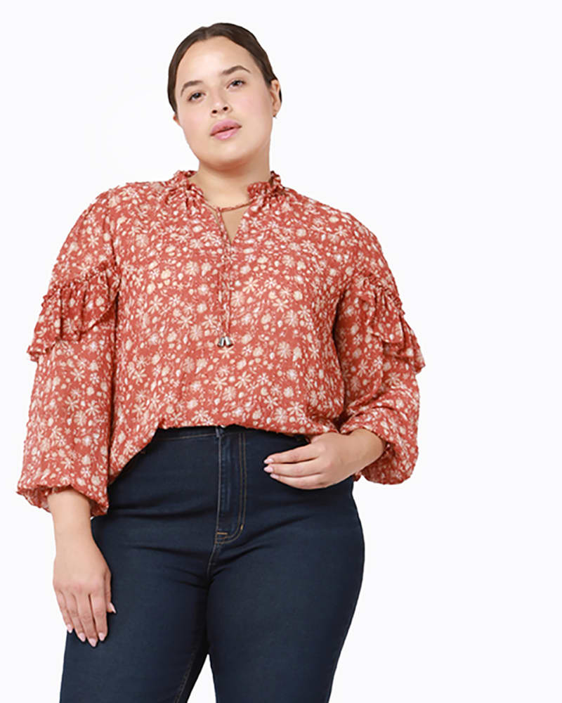 Front of a model wearing a size 0X Raquel Ruffle Shoulder Top in Terracotta / White by DEX PLUS. | dia_product_style_image_id:234122